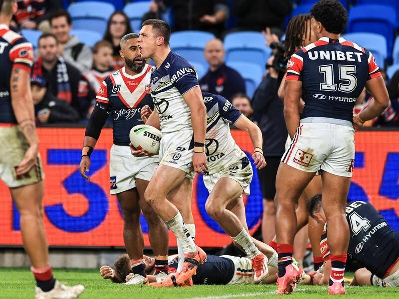 A try by Scott Drinkwater (centre) helped the Cowboys score a thrilling win over the Roosters. (Mark Evans/AAP PHOTOS)
