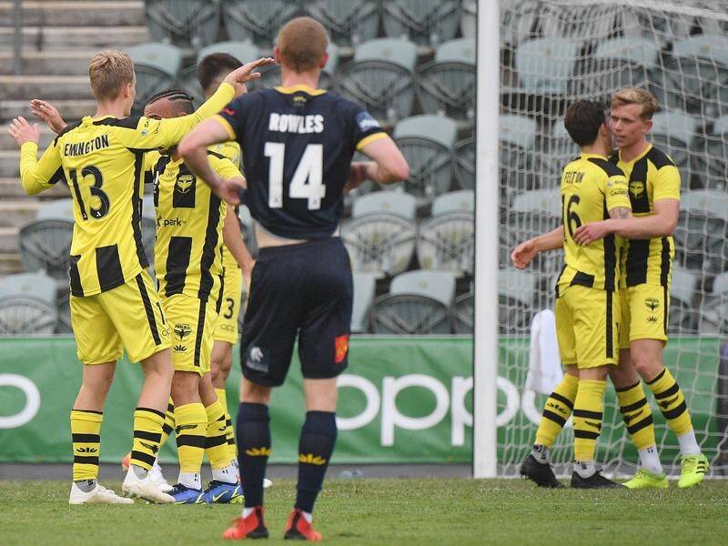 Wellington Phoenix players celebrate their A-League men victory over Central Coast.