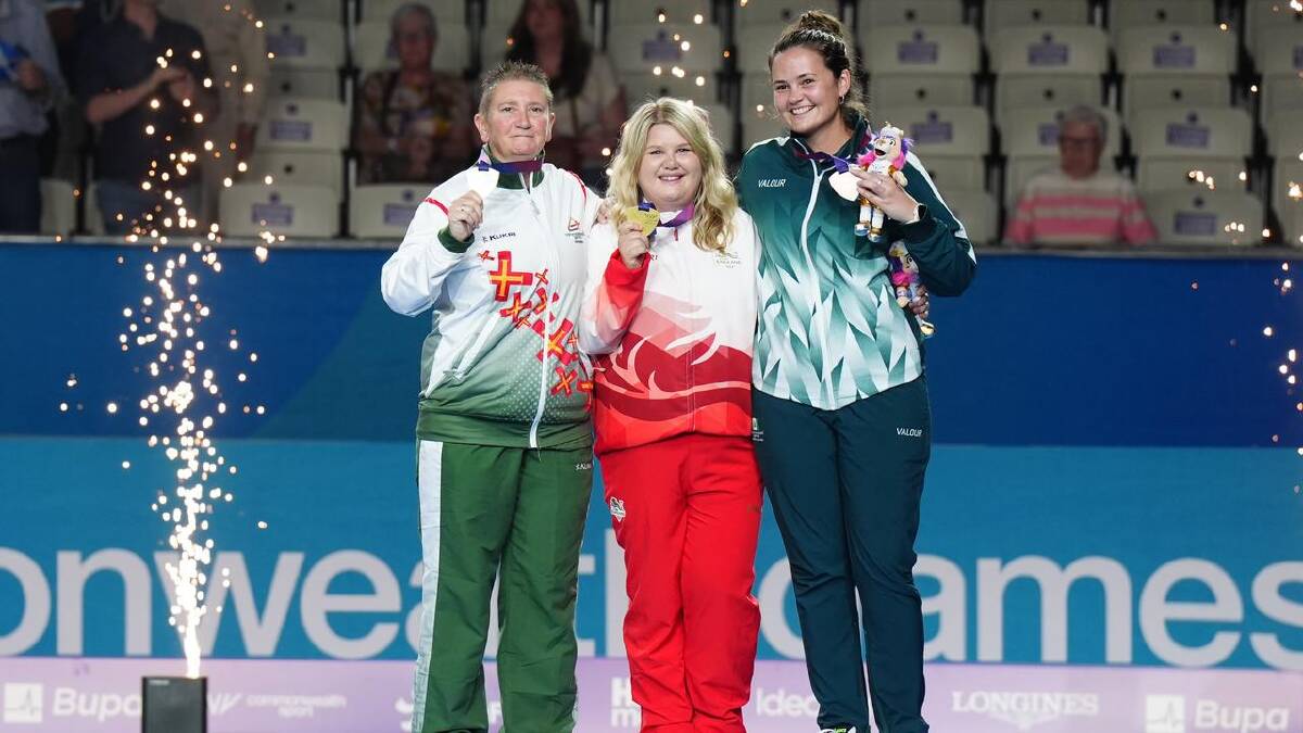 Lawn bowls bronze medallist Shae Wilson (right) was all smiles on the podium in Glasgow. (AP PHOTO) Lawn bowls bronze medallist Shae Wilson (right) was all smiles on the podium in Glasgow. (AP PHOTO)