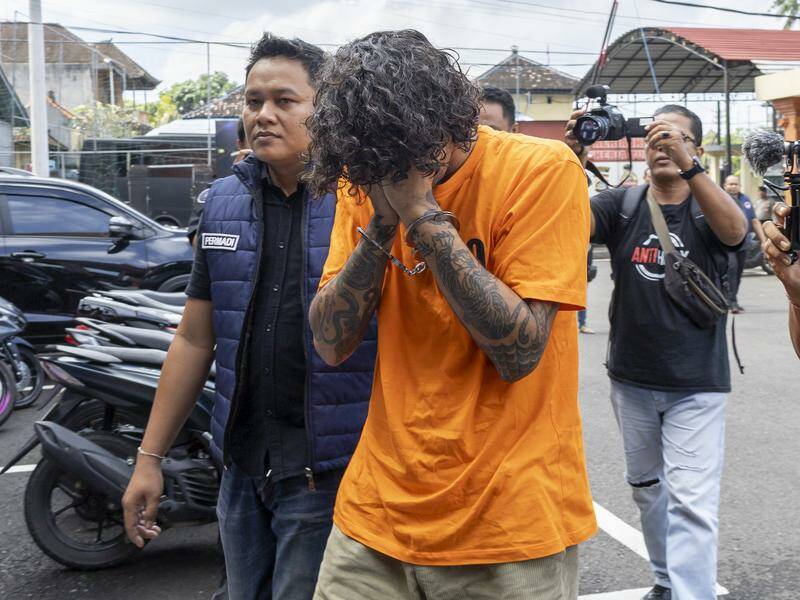 Philip James Nelson is escorted by police following his arrest in Bali. Photo: EPA PHOTO Philip James Nelson is escorted by police following his arrest in Bali. Photo: EPA PHOTO