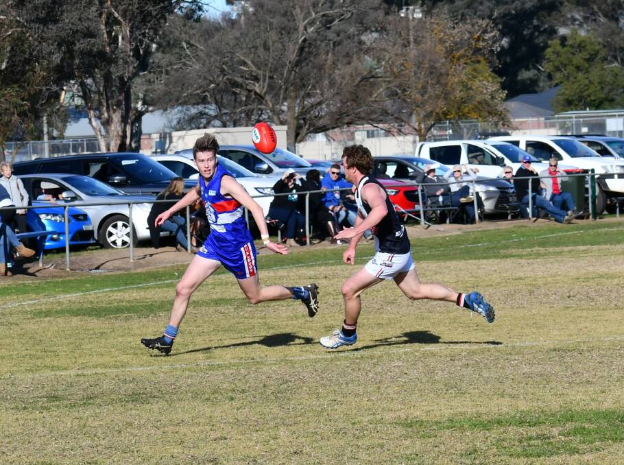 CONTEST: Jindera's Trevor Riley and Brock Burrum Sants' Darcy I'Anson commit to the contest in round 12 of the Hume Football League. Photo: LORRI RODEN