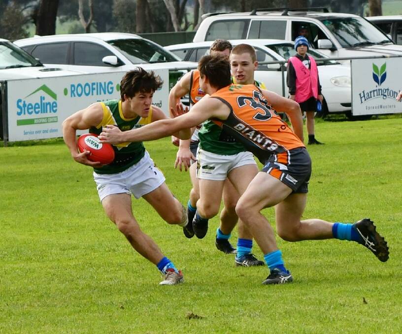 HEAD ON: Holbrook's Lachie Holmes takes on the Giants' Brian Lieschke in the Hume Football League on the weekend. Photo: LORRI RODEN