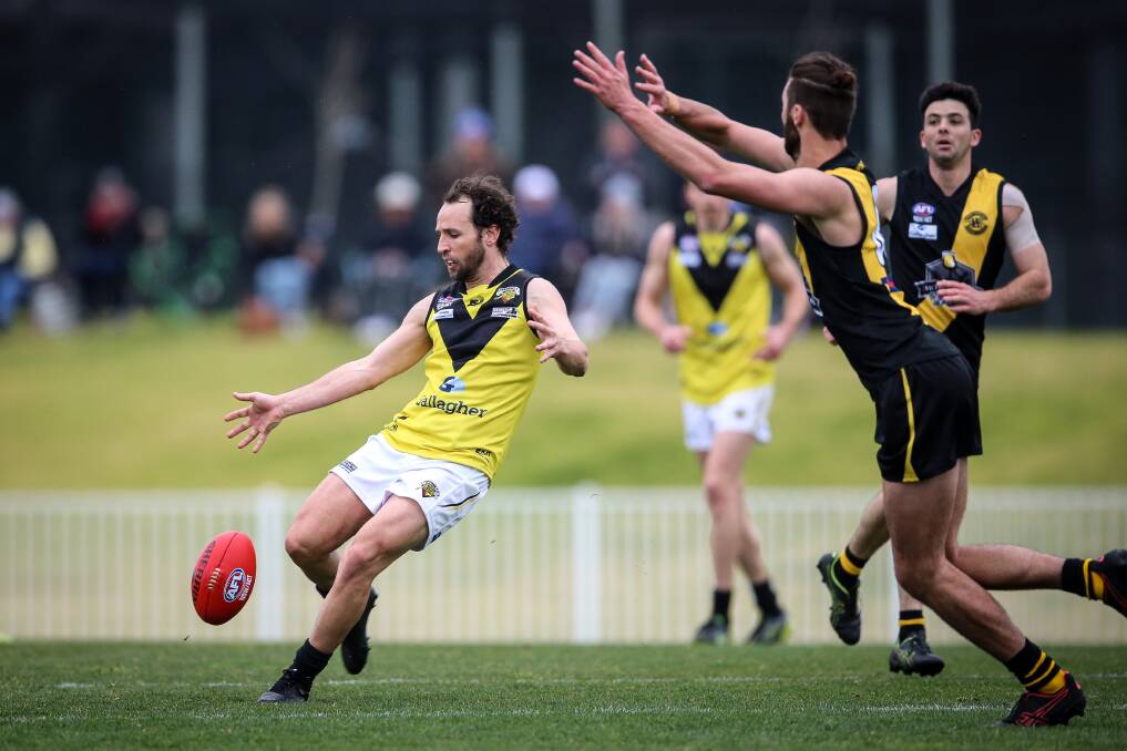 Osborne workhorse Marty Bahr gets a kick away under pressure against Wagga Tigers on Saturday. He kicked a telling goal in the third quarter from a 50-metre penalty. Photo: JAMES WILTSHIRE