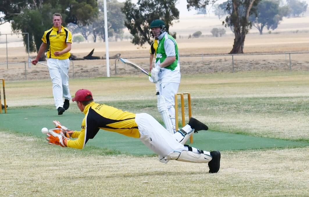STRETCH: Walla Walla's Chris Hutchinson watches on as Osborne wicket-keeper Chad Fuller lunges for the catch.